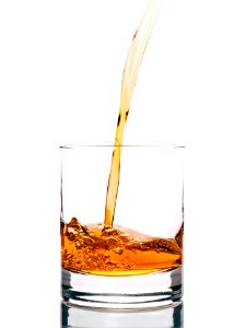 Clear Drinking Glass Filled With Brown Liquid photo