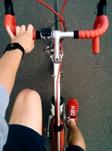 Man Riding on Silver and Red Road Bike photo