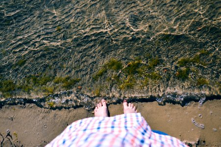 Person Standing Beside Clear Body of Water photo