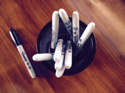 White Sharpie Markets on Table photo