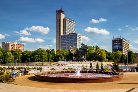 Photography of Two Man Sitting on Bench in Front of Fountain photo