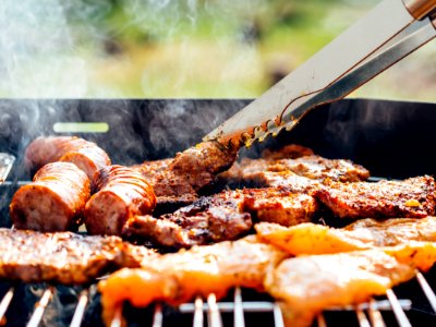 Person Grilling Meats photo