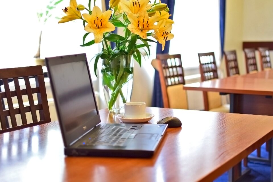 Laptop meeting fresh flowers