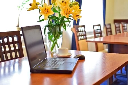 Laptop meeting fresh flowers