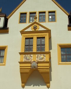 Bay window decorated stucco façade photo