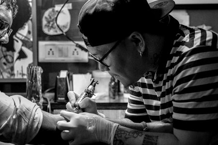 Tattooist tattooing machine photo