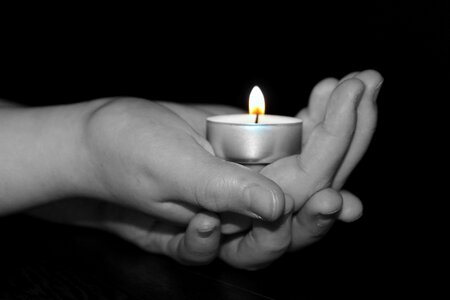 Children's hands interlaid flame