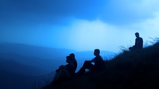 Sitting on hill mountains man silhouette photo