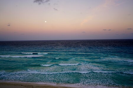 Sunset waves moon photo