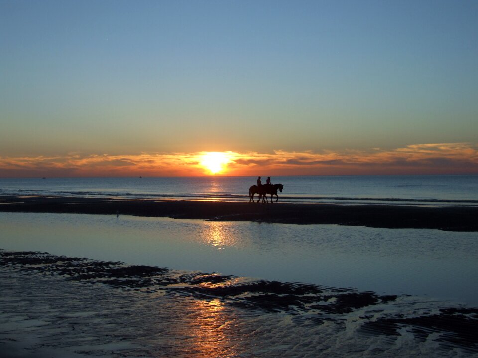 Sunset on the sea horizon riders