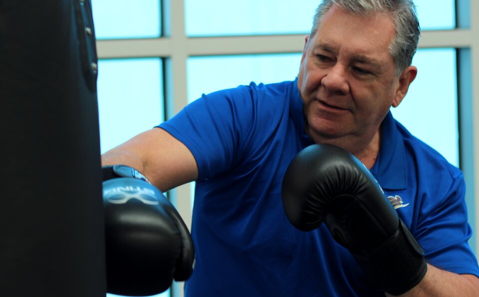 Boxing punching old man