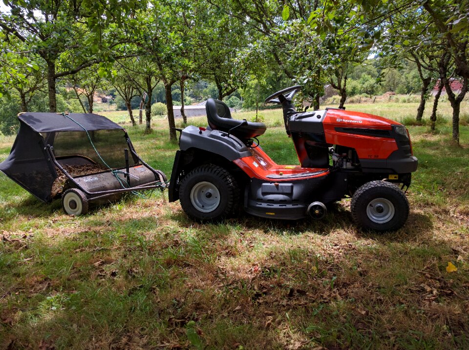 Tractor sweeper leaves apple trees