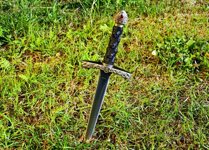 Dagger symbol grass