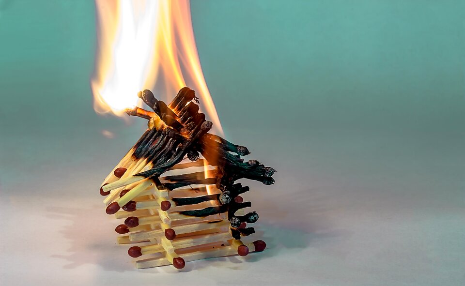 Burning matchstick house spent matchsticks charred matchsticks