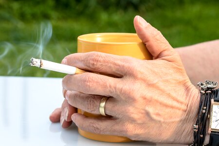 Smoke hand coffee cup photo