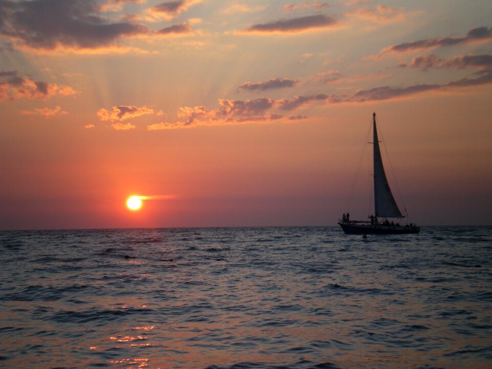 Sea sailboat sunset photo