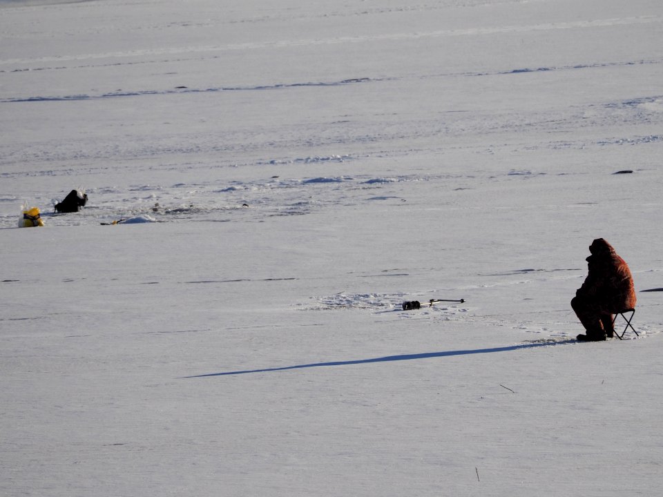 A fisherman, his bag and a long shadow 