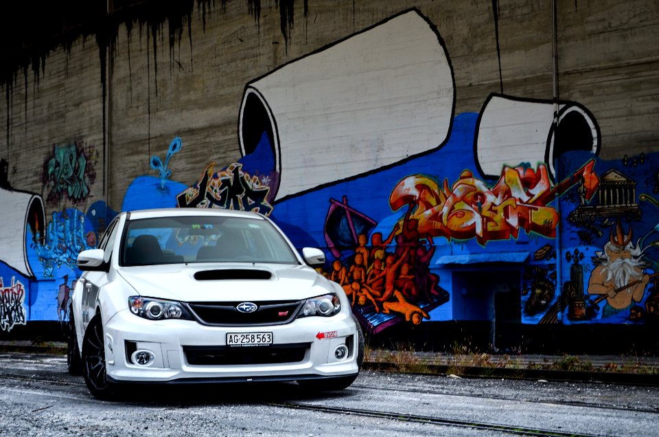 in front of graffiti wall 