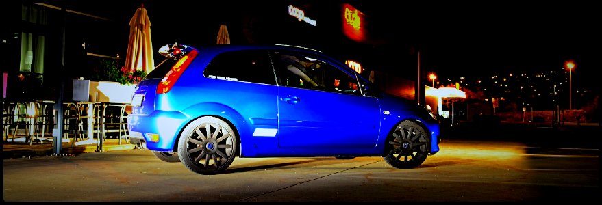 fiesta lighted by cars 