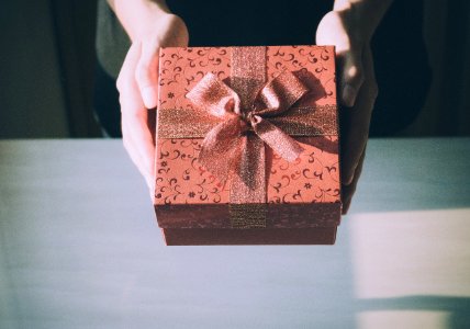 Close up of woman hands holding red gift box for special e… 