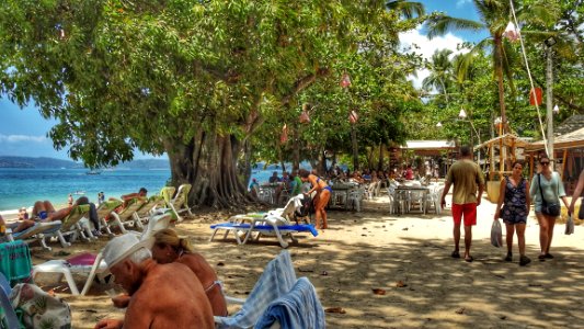 People Flock to Sand Near Water photo