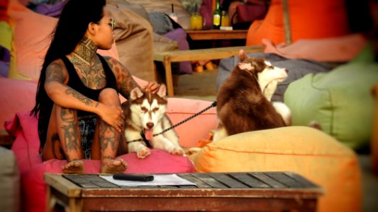 A Tattooed Girl With Her Puppies