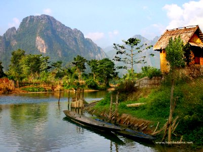 Hut and canoes, Vang Vieng, Laos photo