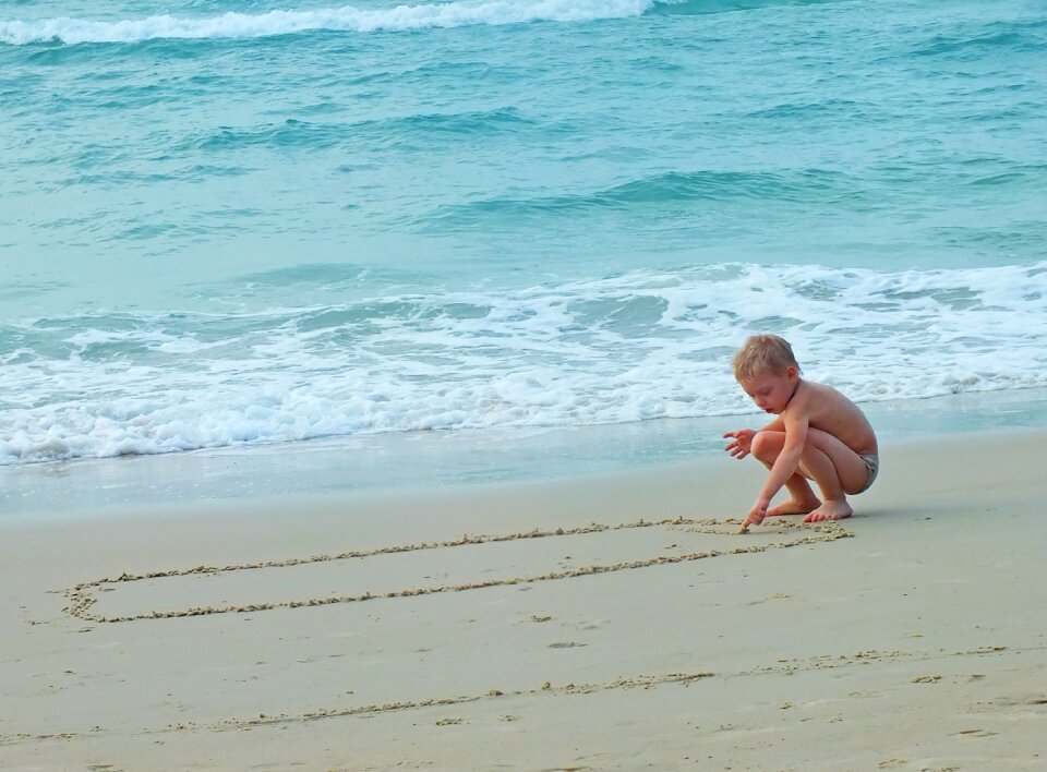 Beach kids drawings in the sand