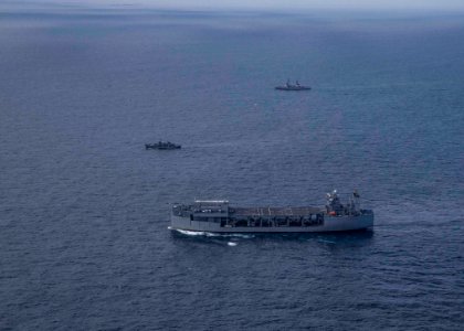 USS Hershel “Woody” Williams conducts fleet maneuvers with…