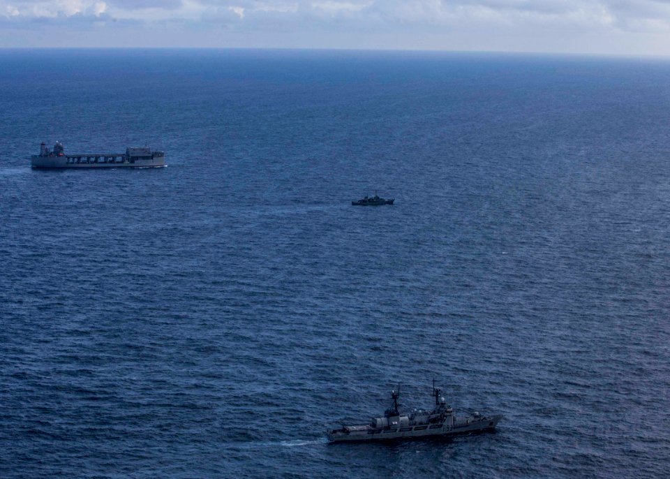USS Hershel “Woody” Williams conducts fleet maneuvers with…