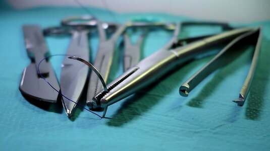 A pair of scissors tweezers vice