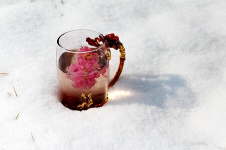 Enamel cup heavy snow close-up photo