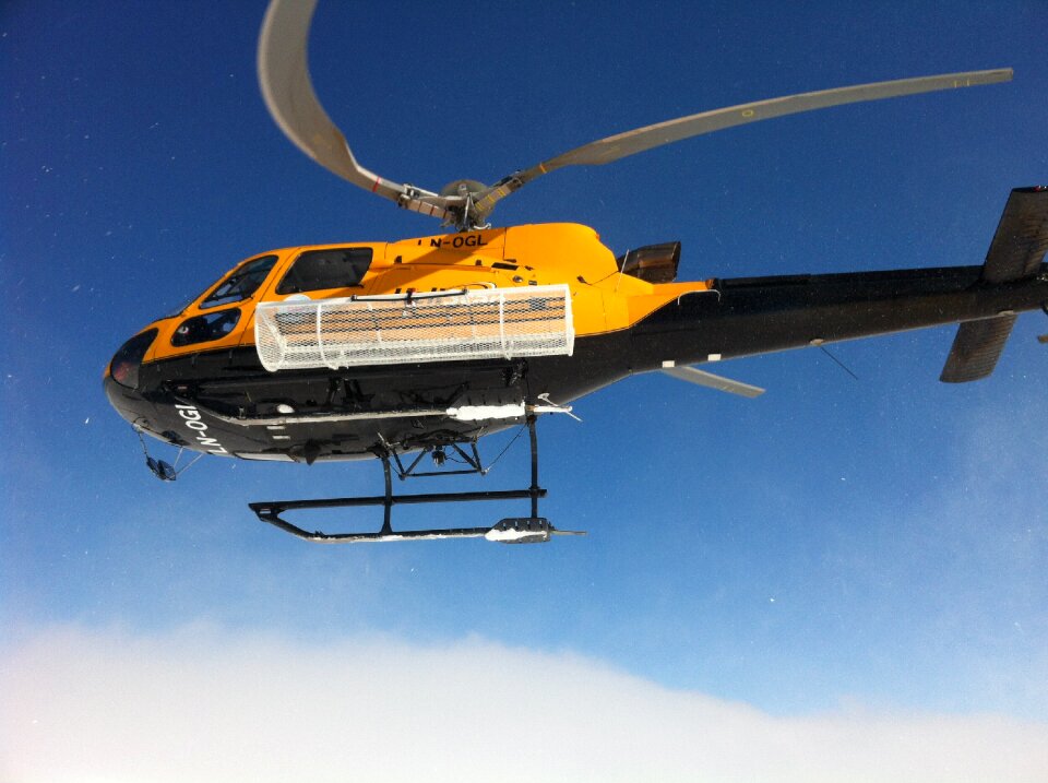 Helicopter lifting swedish mountain winter