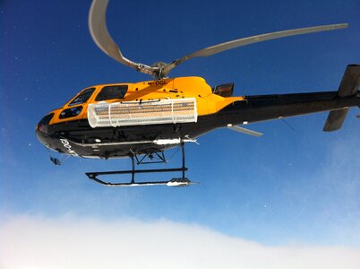 Helicopter lifting swedish mountain winter