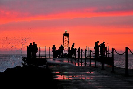 Fishing rod silhouette the sea photo