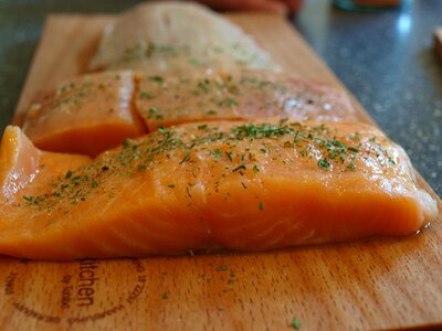 Fish salmon on wooden board grilling fish photo
