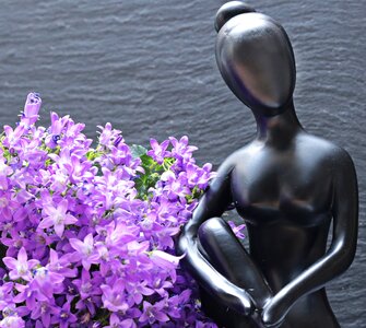 Statue beautiful woman flowers