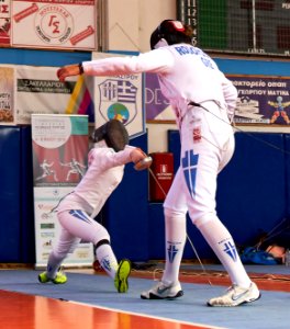 2nd_Leonidas_Pirgos_Fencing_Tournament._Pari_Filippousi_performs_a_lunge_against_Nefeli_Rodopoulou_with_the_intention_of_scoring_a_foot_touch