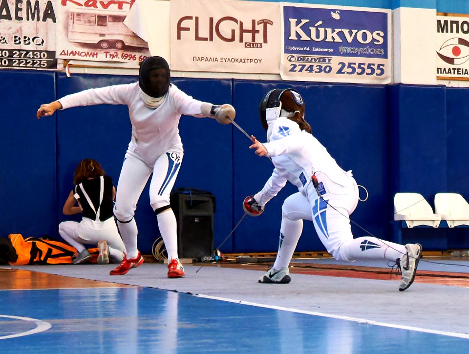 2nd_Leonidas_Pirgos_Fencing_Tournament._Nikoletta_Chatzisarantou_attempts_to_score_a_foot_touch_but_Irini_Mavrikiou_responds_with_a_counter-attack