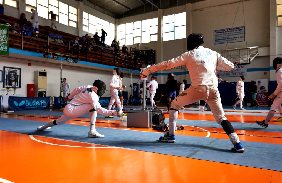 2nd_Leonidas_Pirgos_Fencing_Tournament._Alhussain_Ahmed_strikes_a_hit_on_the_knee_of_Matthew_Baker_and_scores_a_touch