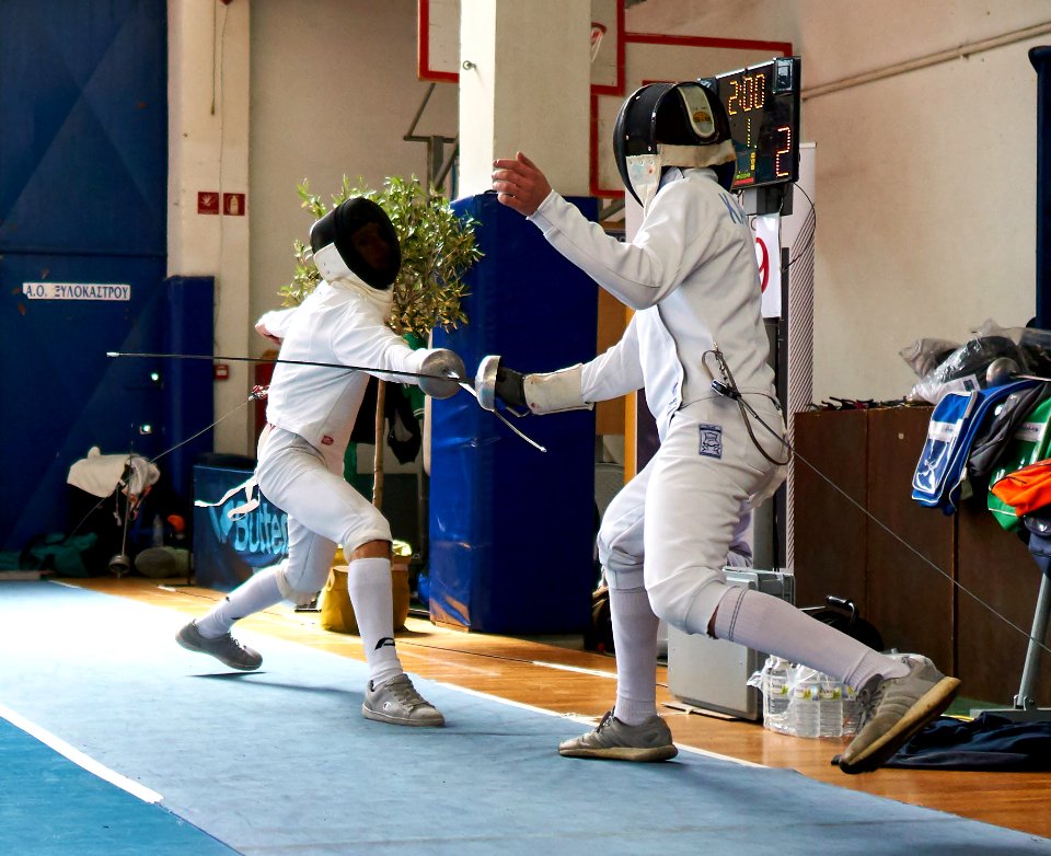 2nd_Leonidas_Pirgos_Fencing_Tournament._Advance_lunge_from_the_fencer_on_the_left,_4th_parry_from_the_fencer_on_the_right