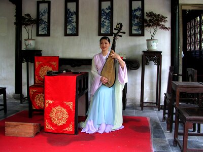 Asian woman rest musical instrument