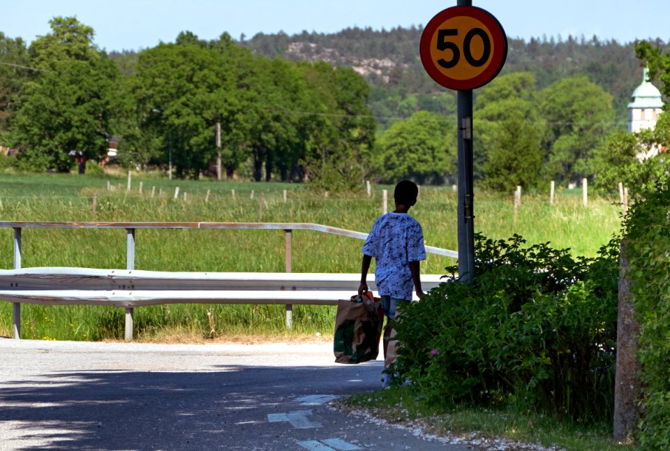 A_boy_taking_bags_of_PET_bottles_to_the_recycling_deposit_at_Tempo,_Brodalen