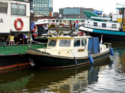 A_view_on_old_boats_on_the_quay_of_Prins_Hendrikkade_in_front_of_Oosterdokseiland_in_Amsterdam;_high_resolution_photo_by_FotoDutch,_2013 photo