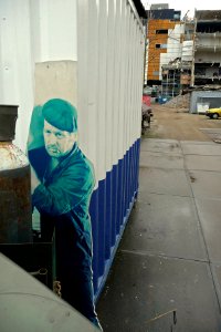 A_photo_of_a_constructioncontainer_with_large_picture_on_the_demolition_site_of_CS_Post-building_in_Amsterdam photo