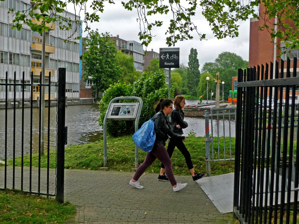 A_photo_of_two_students,_walking_on_the_university_campus_Roeterseiland,_Amsterdam;_high_resolution_image_by_FotoDutch_in_June_2013