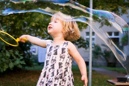 Make soap bubbles children's girl plays photo