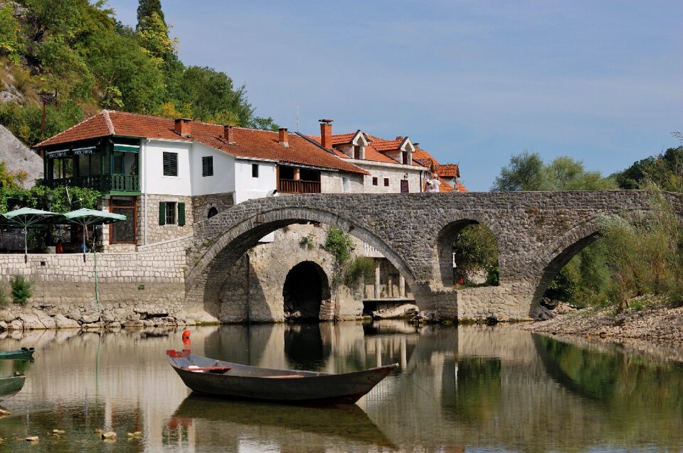 A stone bridge lake boat
