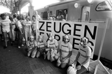 Actievoerders met maskers van een varkenskop voor een spandoek Zeugenexpres, Bestanddeelnr 932-6690