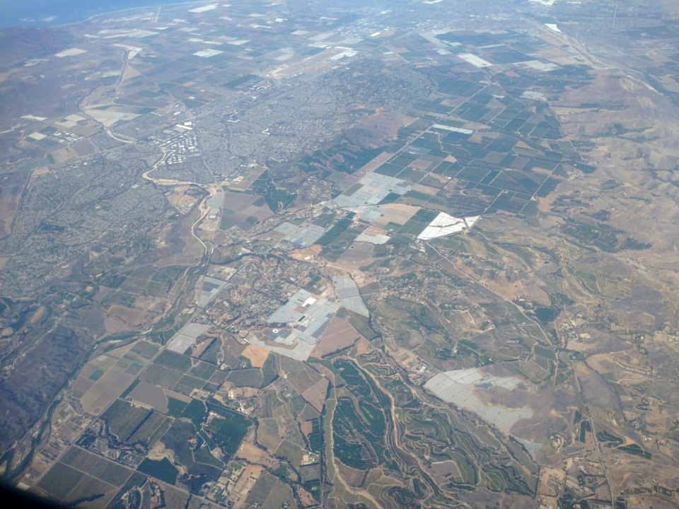 Aerial view of farms in Oxnard, California with plastic-covered fields